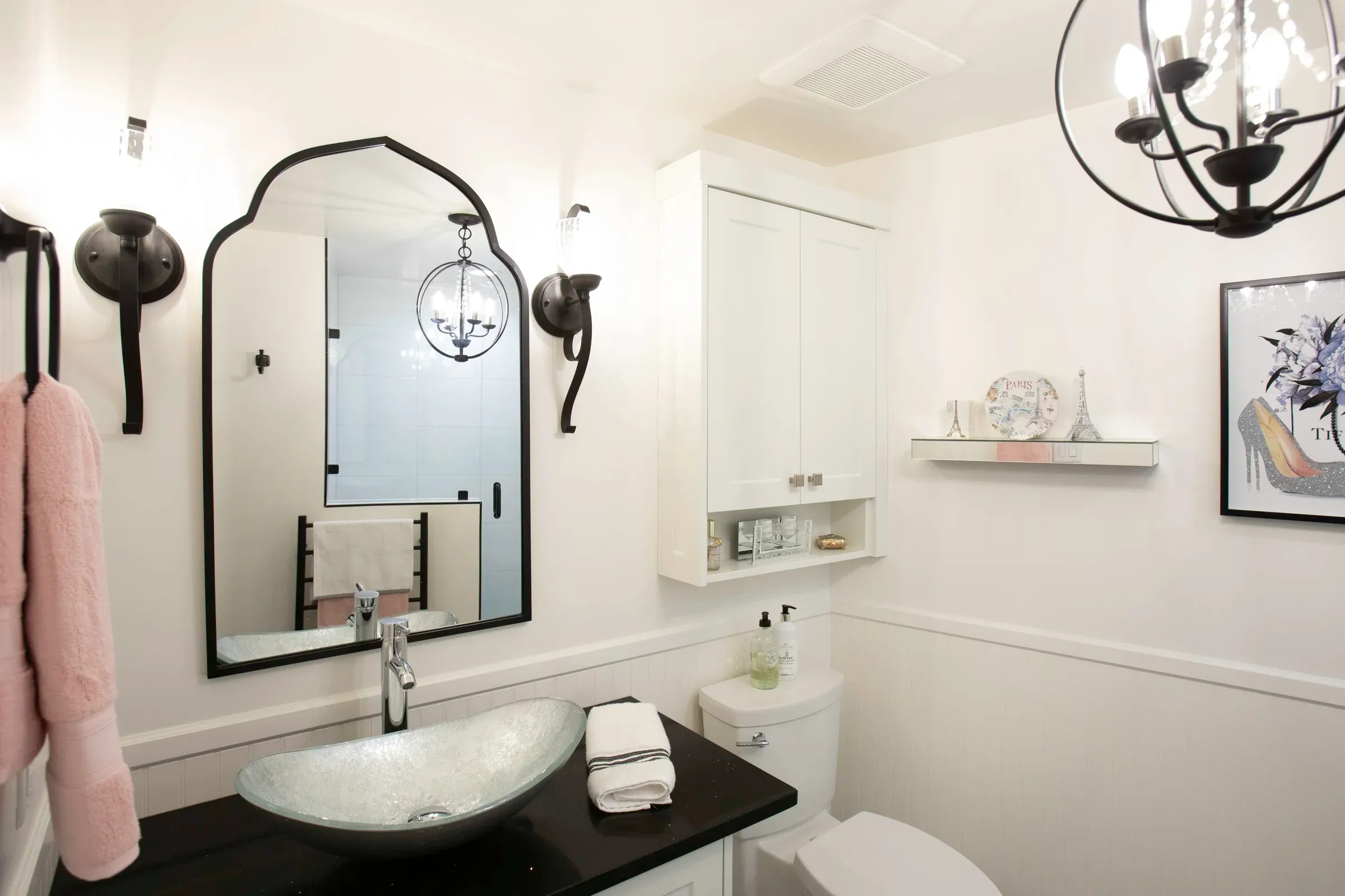 Bright powder room with black fixtures and a vessel sink