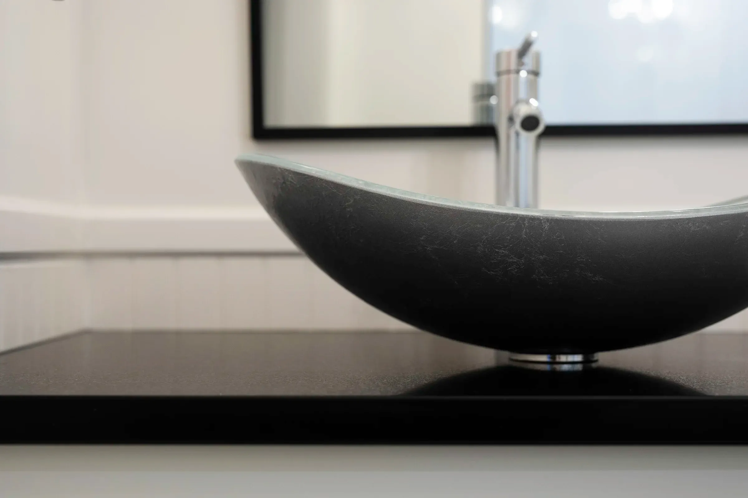Close detail of a sculptural vessel sink